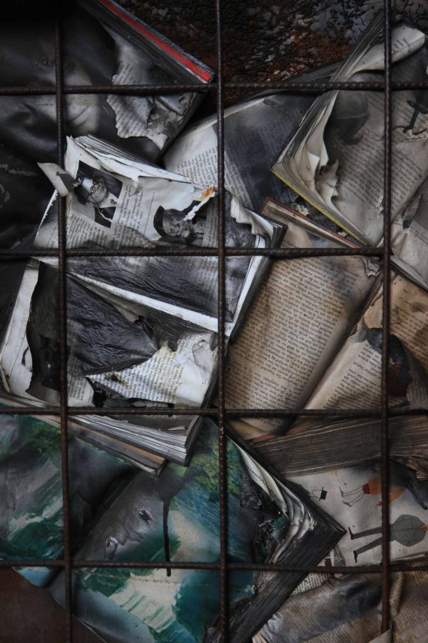 Burning Books contemporary art, evocative scene of books alight in warm sepia tones