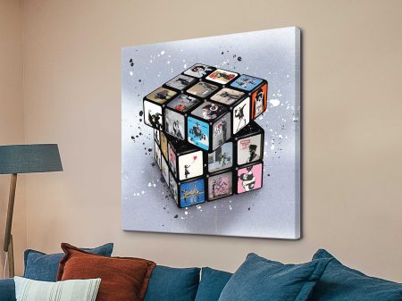 Banksy Rubik's Cube, canvas print, stencil street-art motifs scrambled across the puzzle faces. Banksy Rubik's Cube, canvas print, stencil street-art motifs scrambled across the puzzle faces.
